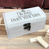 a wooden box with a pair of scissors in it