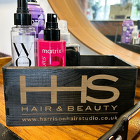 a wooden box with hair and beauty products in it