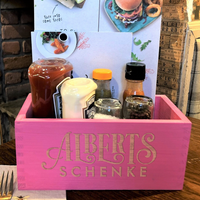 a pink box filled with condiments and condiments