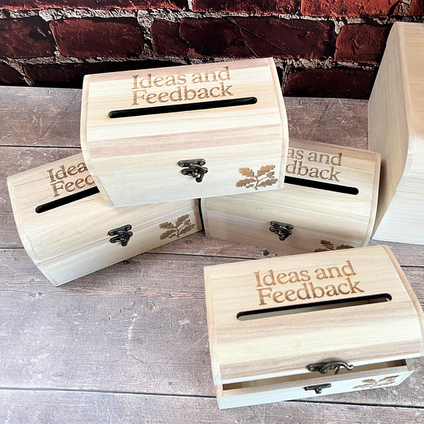 a group of four wooden boxes sitting on top of a wooden floor