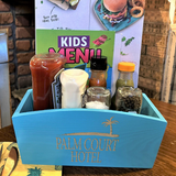 a blue box filled with food on top of a wooden table