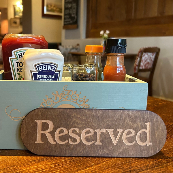 a wooden box filled with condiments and condiments