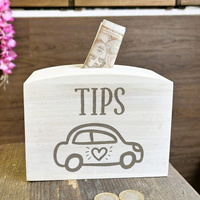 a wooden box with a car and money on top of it