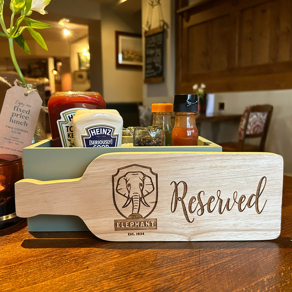 a wooden sign that says reserved sitting on a table