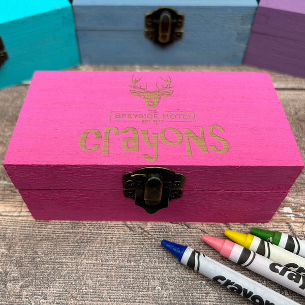 a wooden box with crayons written on it